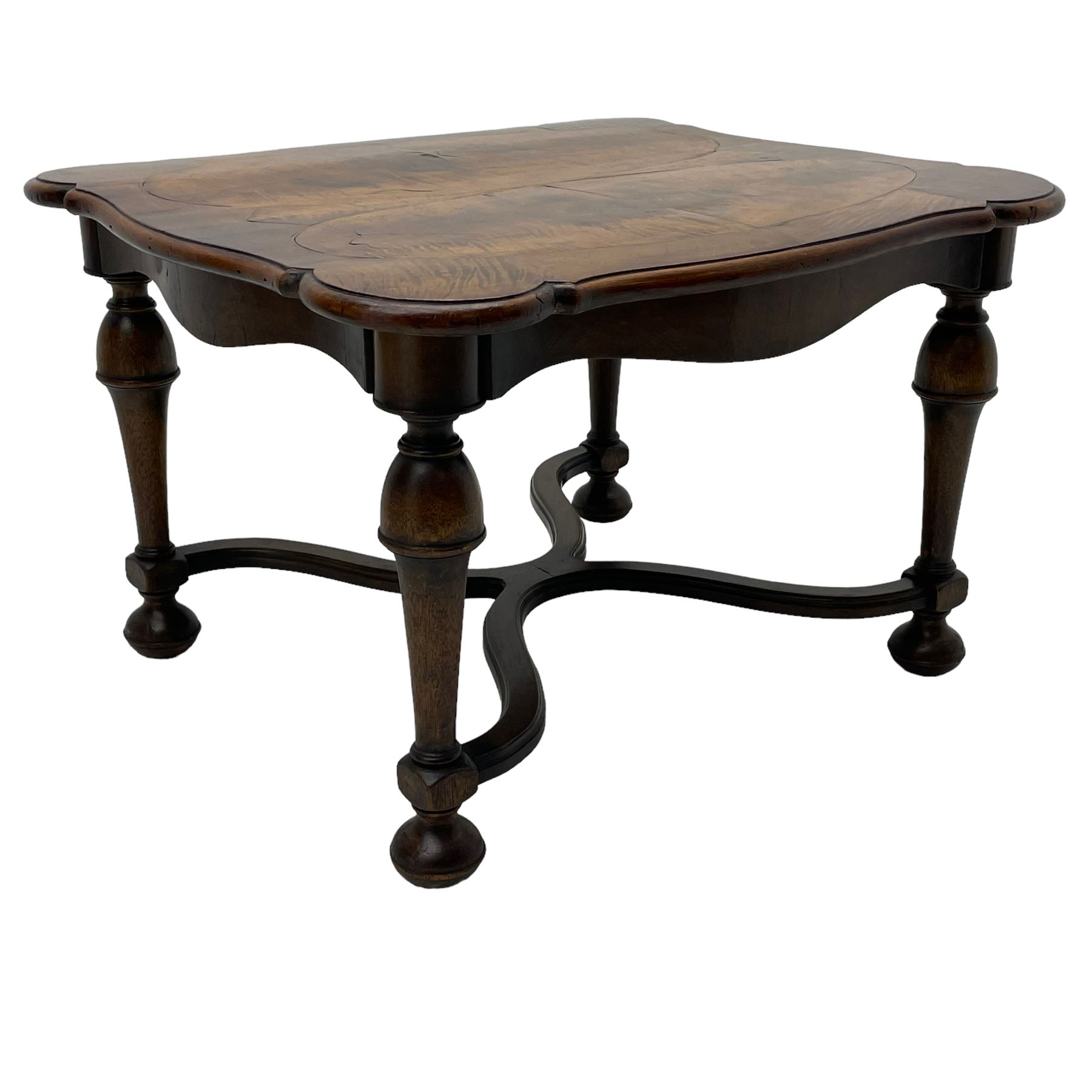 Figured mahogany coffee table, shaped moulded top with oval book-matched veneered panels, on turned supports united by waved X-shaped stretchers 