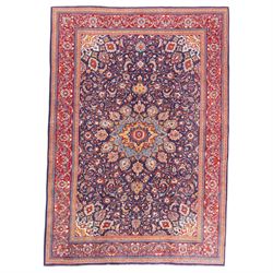 North West Persian carpet, the indigo field centred by a lobed medallion in pale blue and ...