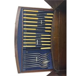 Part canteen of silver plated cutlery, including ivorine handled table and dessert knives, table forks, dessert forks, dessert spoons, teaspoons and soup spoons, all contained within a canteen cabinet converted from a George III mahogany enclosed wash stand