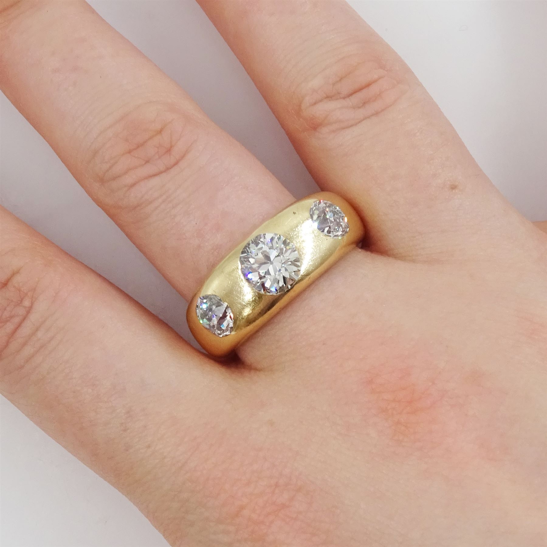 Early 20th century gentleman's gold gypsy set, three stone old cut diamond ring, stamped 18ct, principal diamond approx 1.20 carat, total diamond weight approx 2.50 carat