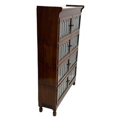 Early 20th century Globe Wernicke design stacking walnut bookcase, fitted with four sections each with two leaded glass doors, raised on turned feet