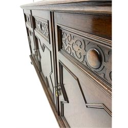 Waring and Gillow - oak bookcase on cupboard, projecting cornice over arcade frieze, guilloche upright decoration, the top section enclosed by three astragal glazed doors, the lower section enclosed by three geometric panelled doors with blind fretwork decoration, on turned feet