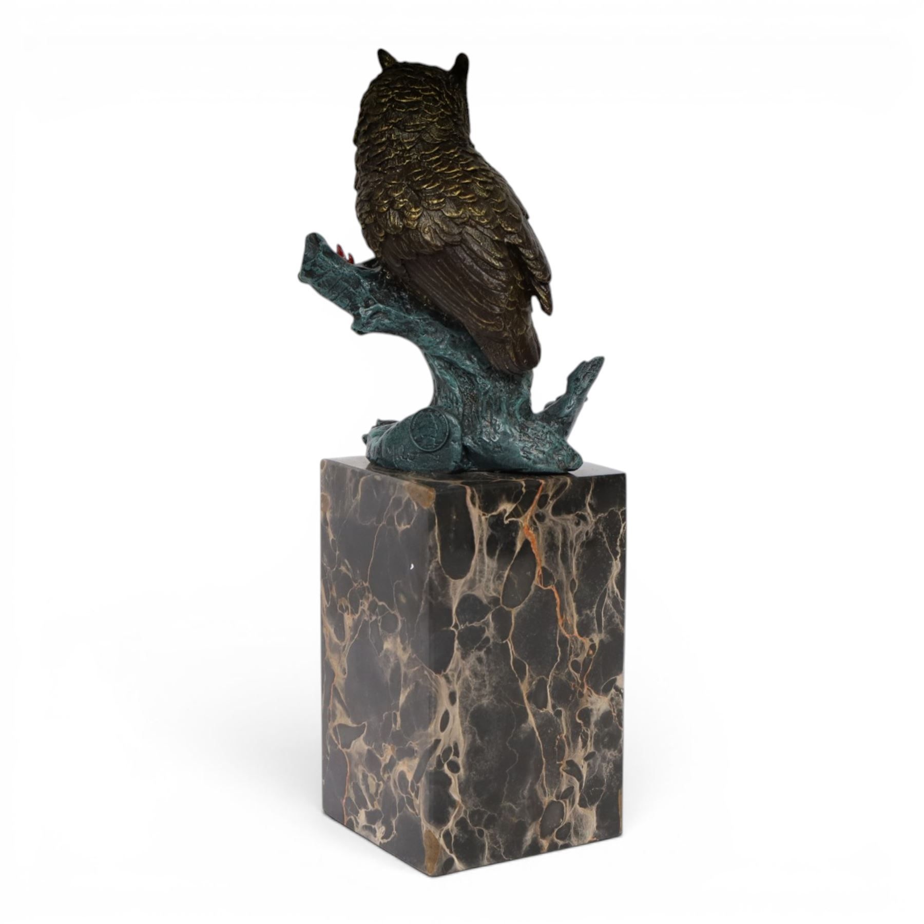 Cold painted bronze figure, modelled as an owl perched upon a tree stump signed Milo and with foundry mark, raised upon black veined marble plinth, H27.5cm