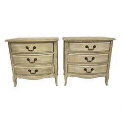 Pair washed finish bow-front bedside chests, fitted with three drawers with chamfered uprights 