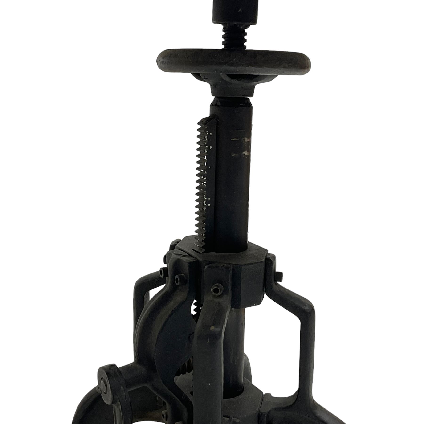 Industrial steel adjustable occasional or bar table, circular top over revolving screw action, raised on four cabriole supports with turning handle to adjust height