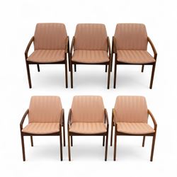 Mid-20th century Danish teak armchairs, each with curved open arms and upholstered seat an...