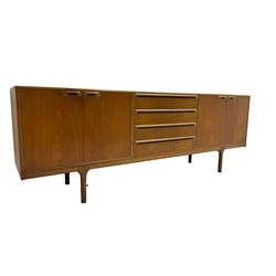 Tom Robertson for AH McIntosh & Co of Kirkaldy - mid-20th century teak sideboard, fitted with four central drawers, flanked by cupboard enclosing shelves and sliding tray, raised on cylindrical supports
