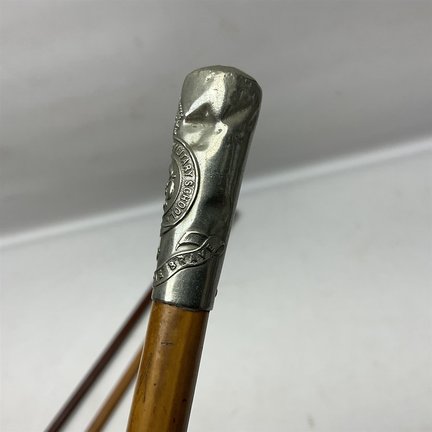 Three malacca cane swagger sticks - Duke of York's Royal military School L68cm; RAMC; and another embossed with a lion to the terminal (3)
