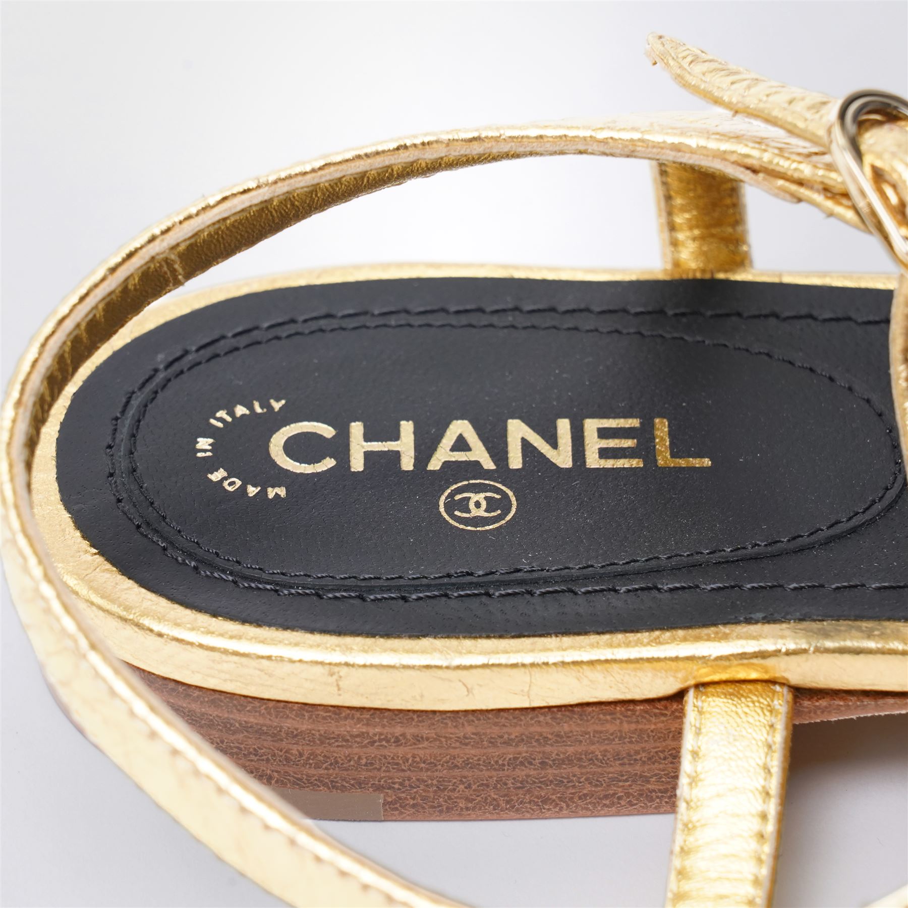 Chanel - pair of gold leather thong sandals, from the 2021 Summer Collection, the uppers centred with an interlocking gold tone CC motif in chain and leather, size 37C, unused with original dust bags