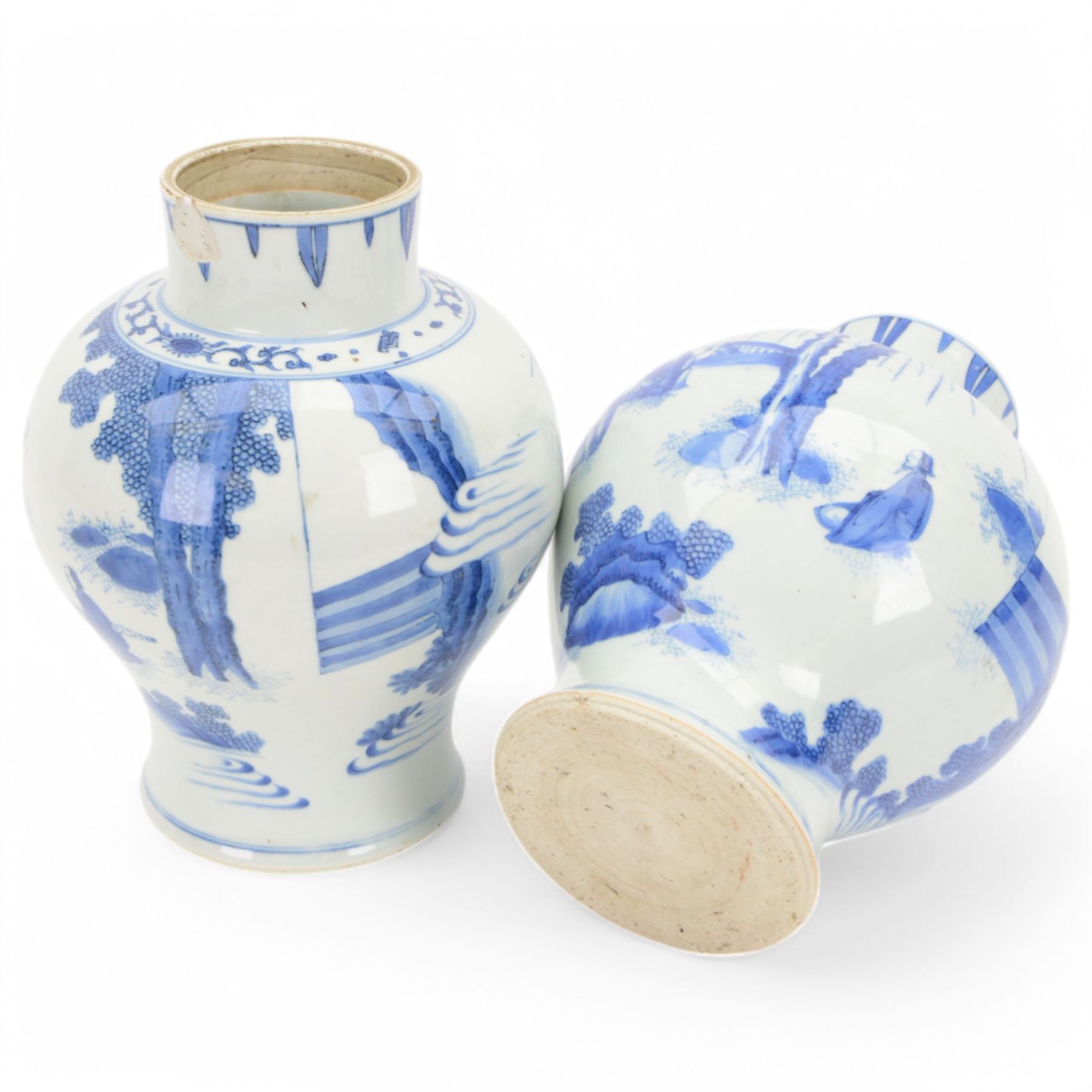 Pair of Chinese Kangxi blue and white porcelain vases, each of baluster form, painted with an outdoor scene containing figures seated upon the ground reading scrolls and holding fans, willow and bamboo tress, rock work and water, H27cm