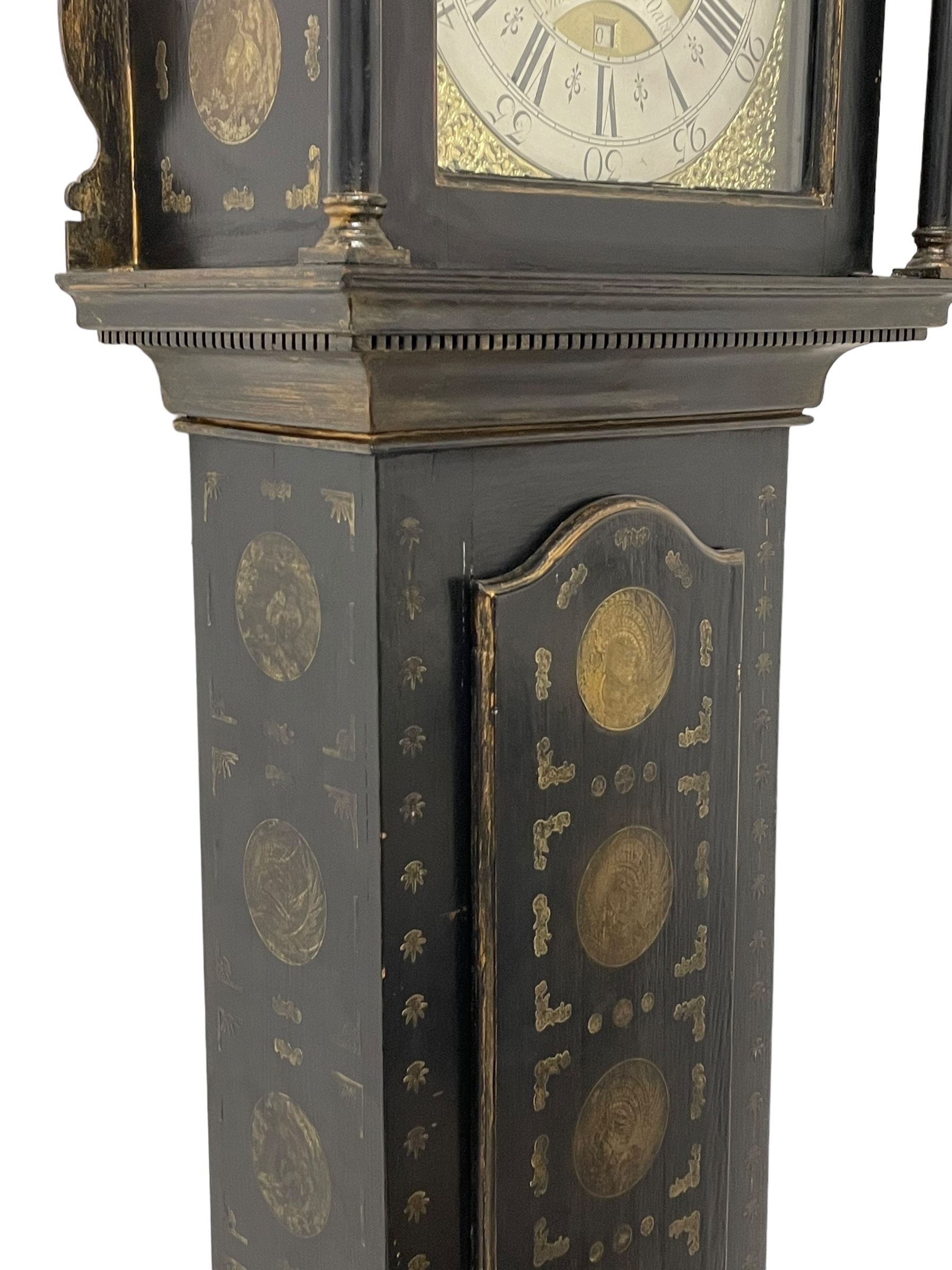 James Bowra of Sevenoaks Kent - 18th century 8-day ebonised longcase clock with gilt decoration c1740, with a flat top, dentil moulding beneath and shaped back splats, break arch hood door flanked by plain pilasters with wooden capitals, long trunk with a curved topped door, on a square plinth with canted corners and raised on a moulded base, brass dial with cast spandrels and a silvered 'Punch' automata to the arch, matted dial centre with seconds ring and date aperture, silvered chapter ring with Roman numerals, five minute Arabics, minute and quarter hour tracks, with matching steel hands and silvered makers name plate, rack striking movement with a recoil anchor escapement, striking the hours on a bell. With weights and pendulum.