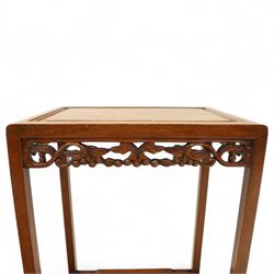 Early 20th century Chinese style hardwood quartetto nest of tables, each with panelled top and carved and pierced vine motif frieze, on square legs united by straight stretchers