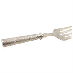 German silver handled four pronged fish serving fork, the tapering cylindrical handle with chased and repousse foliate decoration, engraved with monogram, stamped 800 with crescent and crown mark, L28cm

Notes: By vendor repute belonged to 7th Baron Brownlow 