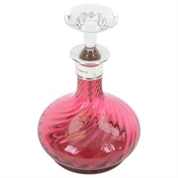 Two modern silver mounted glass decanters, the first a cranberry glass example, with fluted body, clear stopper and silver collar, hallmarked Barker Brothers Silver Ltd, Birmingham 2001, together with a clear cut glass example with silver collar, with import marks for London 1985, tallest H25.5cm