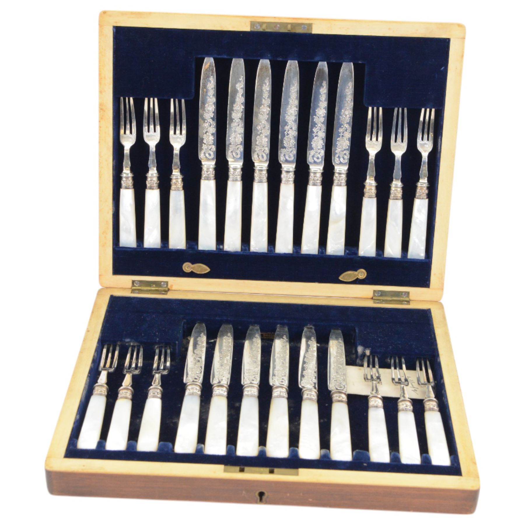 Set of twelve mother of pearl handled silver fruit knives and forks, the knives with floral engraving to blades, hallmarked to both collars and blades/prongs, Frederick C Asman & Co, Sheffield 1906, contained within fitted wooden case with velvet lined interior