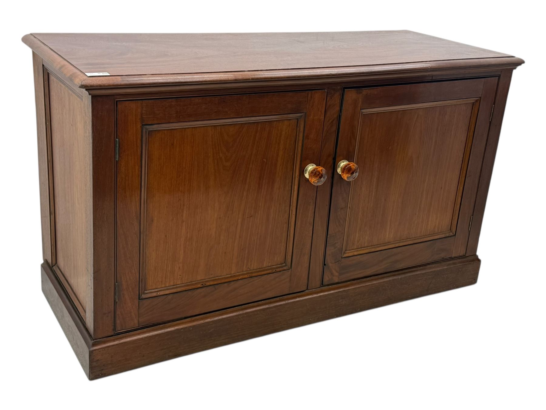Victorian mahogany cupboard, plain rectangular top above two fielded panel doors opening to shelved interior, raised on a moulded plinth base, with later replacement knob handles