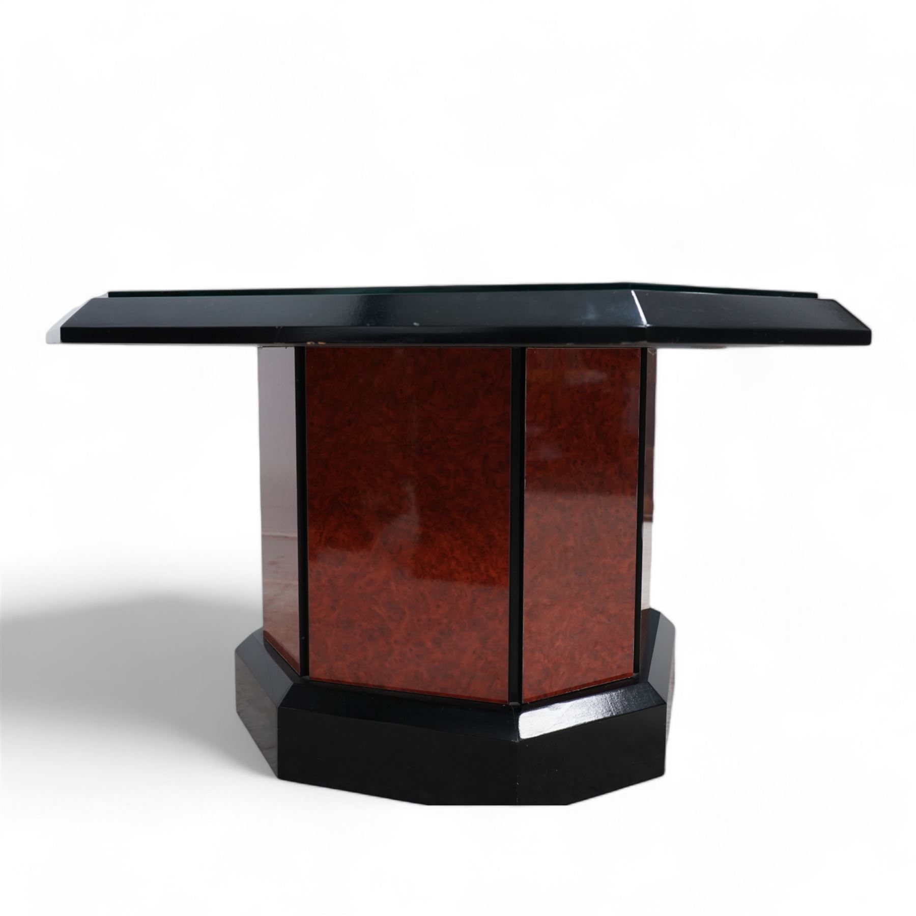 1980s figured wood finish and black lacquered coffee table, square canted top with chamfered edge, on canted pedestal with plinth base 