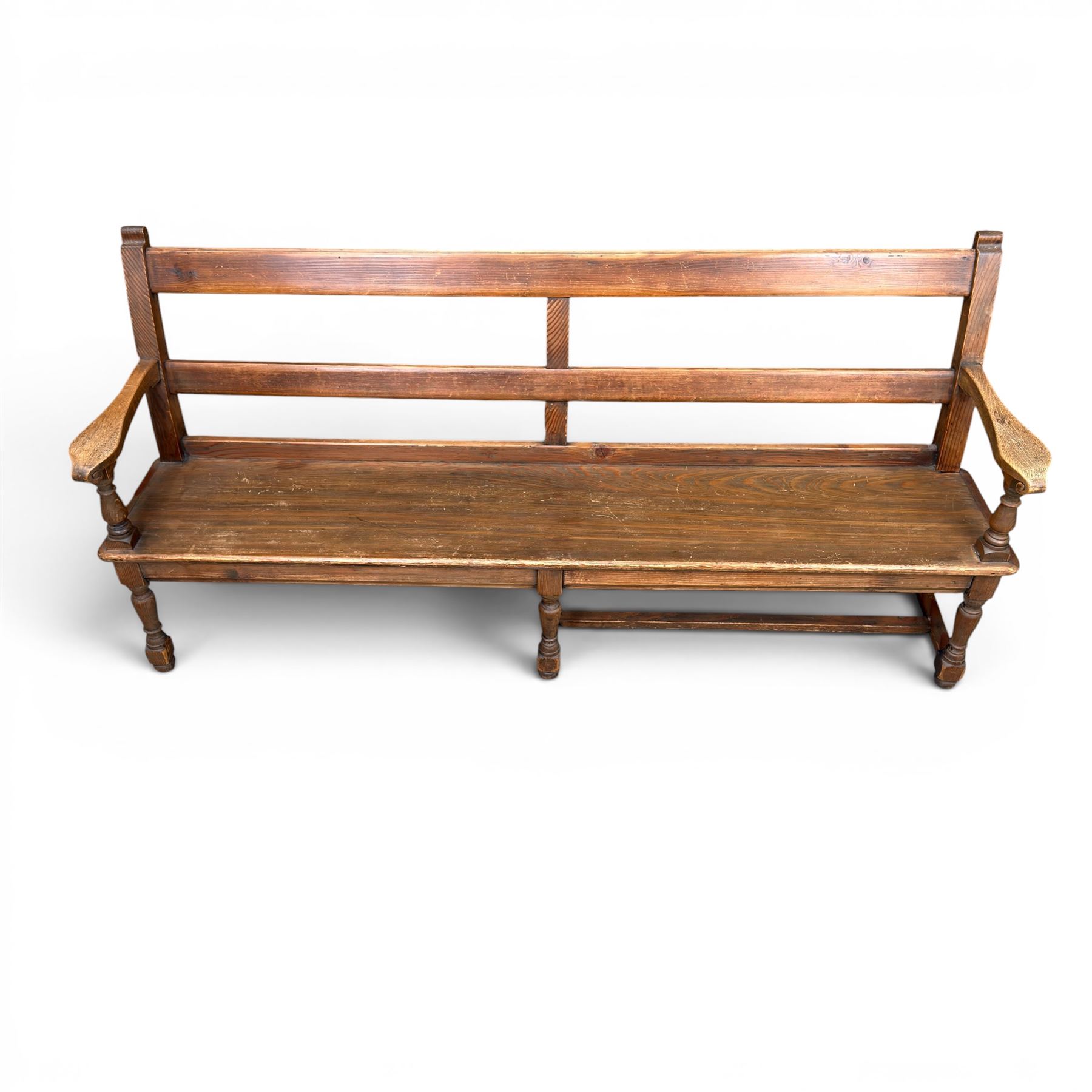 Early 20th century pine and oak bench seat, stained pine rail back frame with shaped oak arms