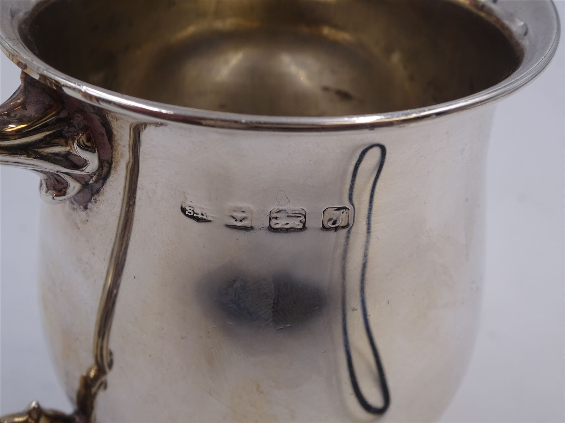 1930s silver Christening mug, of plain waisted form, with acanthus capped scroll handle, upon stepped circular foot, hallmarked Barker Brothers Silver Ltd, Birmingham 1933, including handle H10cm 