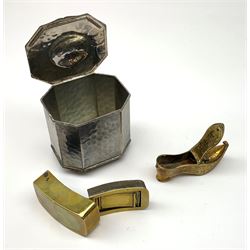A 19th century brass three compartmented snuff box, of curved oblong form, L7.5cm, together with a later brass box in the form of a shoe, and an Arts and Crafts style Cobral Ware planished box, with canted corners and four bun feet, H10cm. (3). 