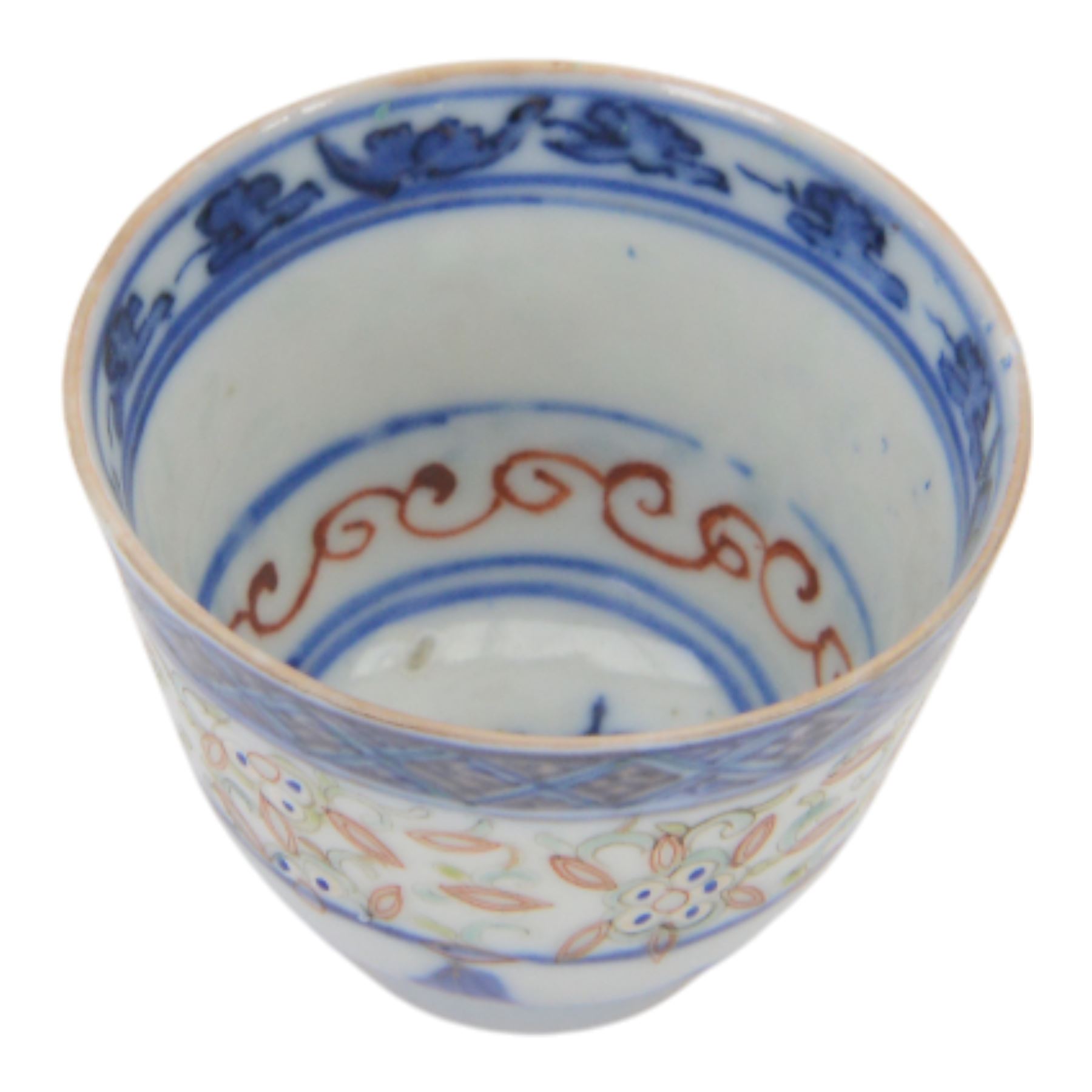 Chinese late Qing Dynasty Guangxu period rice grain detailed teabowl and saucer, each decorated in underglaze blue with flowers and foliate borders, and further detailed with iron red and pale green band of flower heads, and scrolling bands, teabowl with apocryphal Kangxi mark beneath and saucer with apocryphal Qianlong mark beneath, teabowl H5cm, saucer D10cm