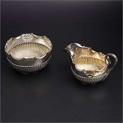 Late Victorian silver cream jug and sugar bowl of fluted circular form, the jug with Art N...