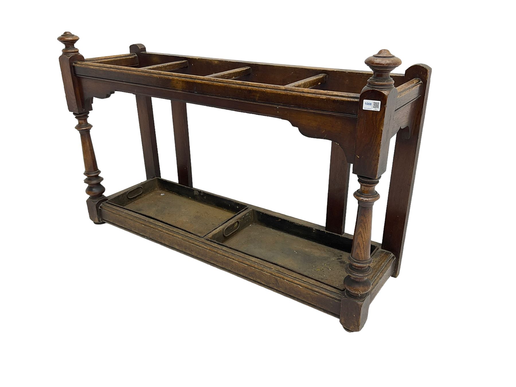 Edwardian oak hallway stick and umbrella stand, four divisions on turned supports, with metal tray liners and various sticks