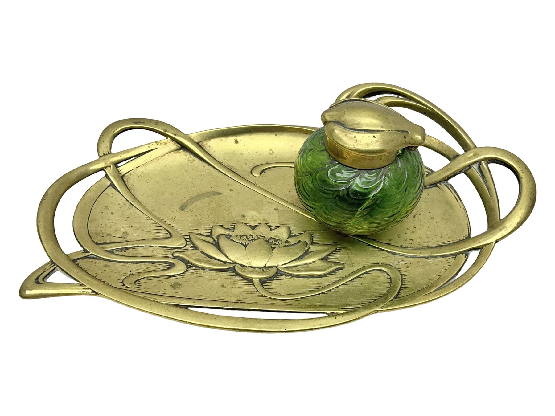 Art Nouveau Geschutzt brass desk stand, with stylised whiplash relief decoration, with removable Loetz style green glass inkwell, stamped to the base, H8cm