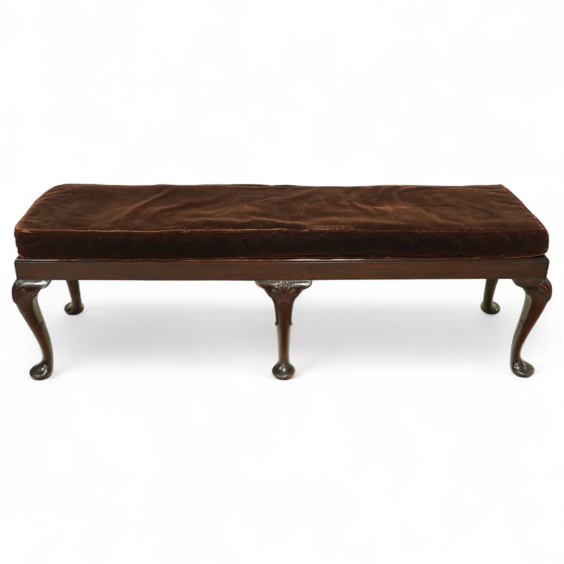 Early 20th century mahogany window seat in the George II style, with rectangular padded seat upholstered in brown velvet, raised on cabriole legs with carved shell knees and pad feet