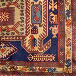 North West Persian Ardebil hand-knotted runner, indigo blue field composed of a repeating series of large stepped octagonal medallions enclosing a central hooked motif and stylized rosette, flanked by angular ivory and madder red latch hook devices, medallions linked by smaller geometric diamonds and serrated lozenges, guard borders with reciprocal motifs and main ivory border decorated with angular vines, with cotton fringe ends 