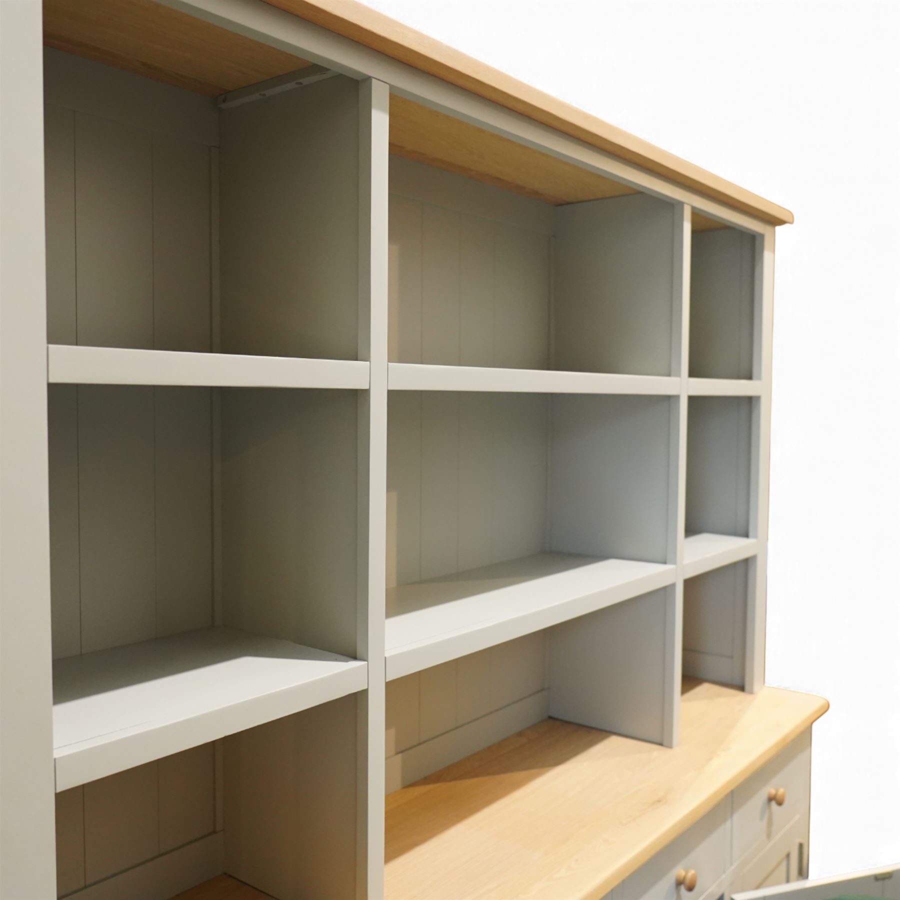 Cotswold Company - 'Chester' dresser painted dove grey with contrasting oak top, the upper rack divided into nine open shelves with panelled back, the lower section fitted with four drawers and cupboard doors enclosing storage compartments