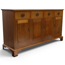 Acornman - mahogany sideboard, rectangular top over four drawers and four panelled cupboard doors with brass handles, on bracket feet, with signature carved acorn, by the workshop of Alan Grainger of Brandsby