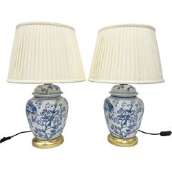 Pair of table lamps of baluster form, decorated with exotic birds up fruiting trees, on gilt chrome pedestals, including shades H55cm