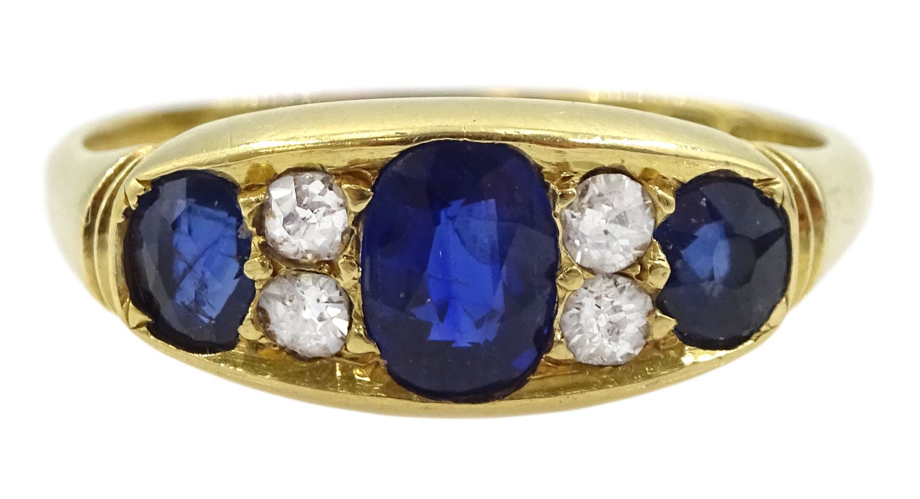 Victorian 18ct gold three stone oval sapphire ring, the central sapphire with two old cut diamonds set either side, Birmingham 1898, total sapphire weight approx 1.00 carat