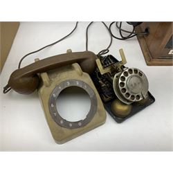 Early-mid 20th century internal telephone system, comprising exchange box with attached TMC rotary telephone and dictograph with Bakelite handset and support upon stained wood case, and 1960s black Bakelite telephone model 312L with G.P.O sticker beneath, largest H30.5cm W36.5cm D30cm