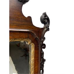 19th century Chippendale design wall mirror, the pierced cresting finial carved with extending foliate decoration, flanked by a broken pediment with moulded acanthus decoration, trailing foliage and flower heads, rectangular plate within a gilt moulded slip, the carved uprights decorated with foliate garlands, the terminal carved with a recessed rosette