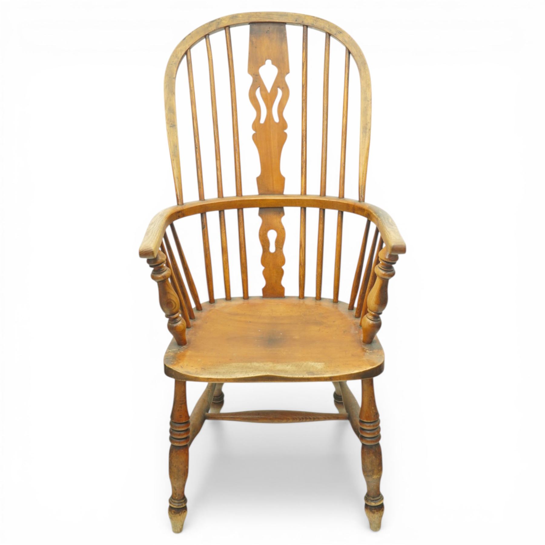 Set of two late 19th century elm and beech Windsor armchairs, each with hoop backs and turned spindles, shaped central splats, solid seats and turned supports united by H-stretchers