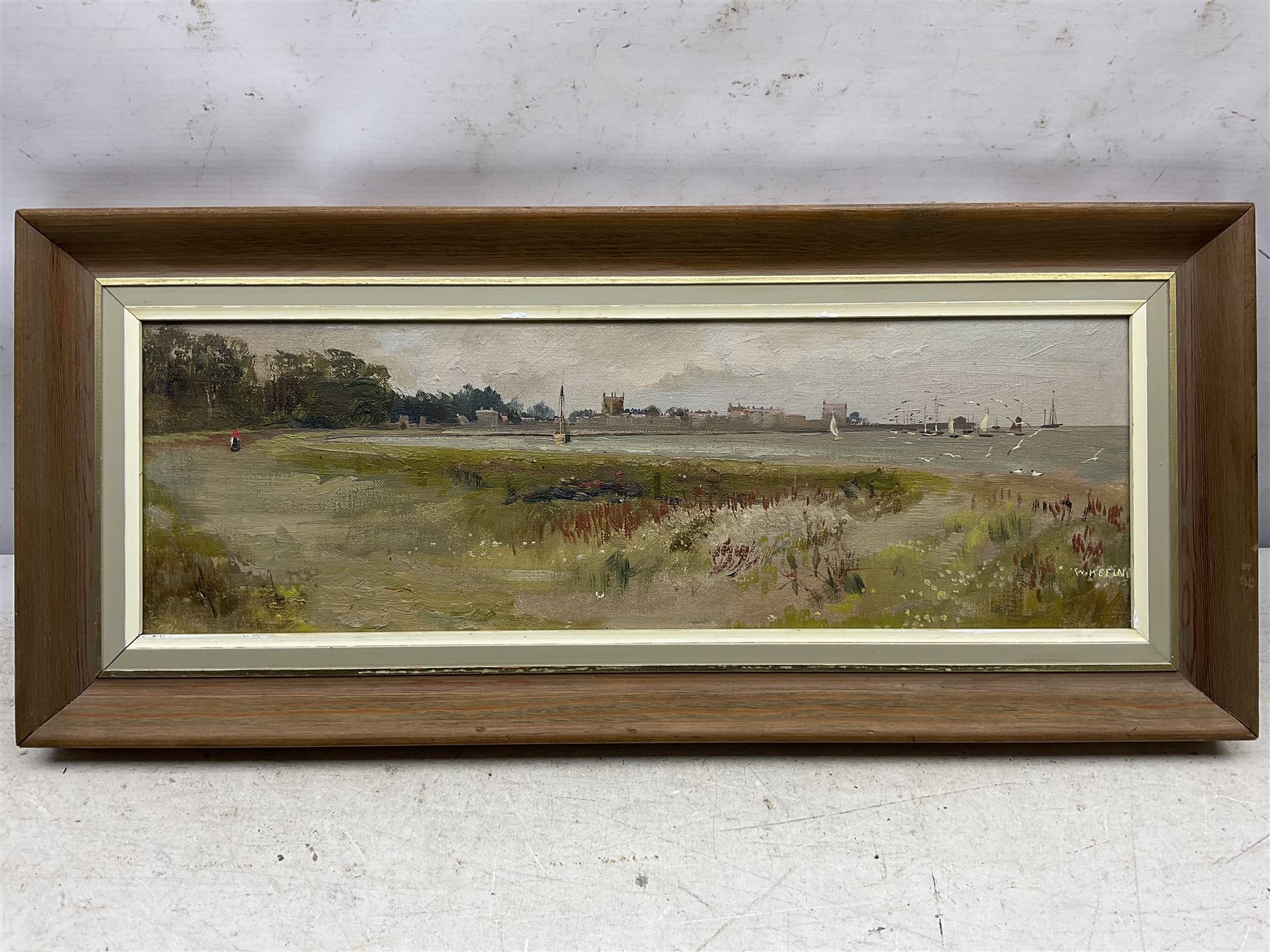 W Keeland (British 20th Century): Coastal Town, oil on board signed 15cm x 47cm; William 'Bill' Wedgwood (British c1934-2019): Ravenscar from Robin Hoods Bay, watercolour signed, max 15cm x 47cm (2)