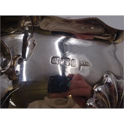 Victorian silver sauce boat, of typical plain form, with shaped rim and acanthus capped flying scroll handle, upon three hoof feet, hallmarked Walker and Hall, Sheffield 1899, including handle H12cm