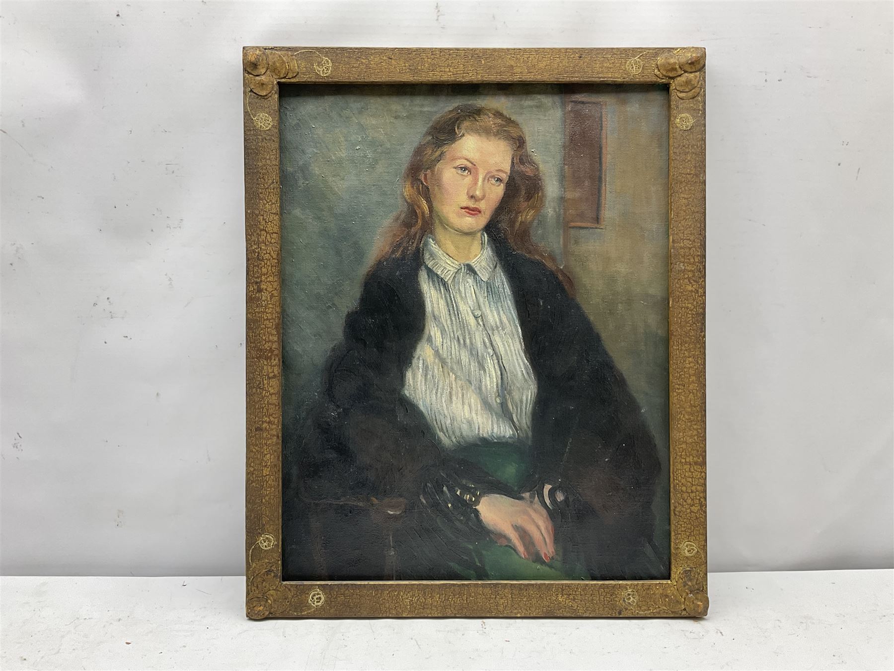 Jean Thompson (British mid 20th century): Half length Portrait of a Young Woman, oil on canvas laid on board unsigned, artist's address '80 Bebington Rd. Birkenhead' verso 47cm x 37cm