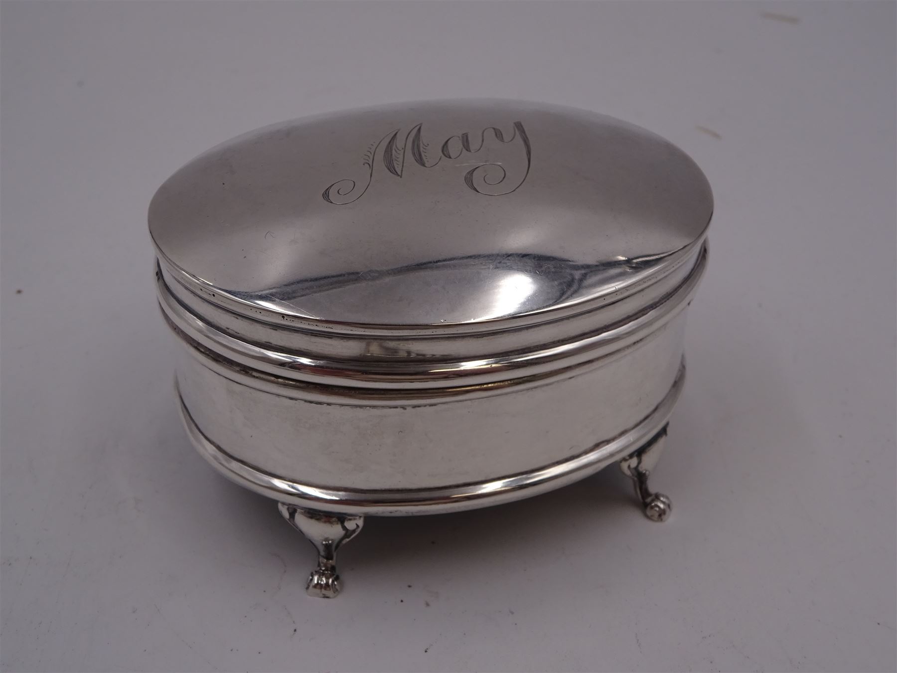 Edwardian silver card case, of rectangular form with shaped outer edge and engine turned linear decoration to body, with central monogrammed circular cartouche, H9.2cm, hallmarked Deakin & Francis Ltd, Birmingham 1903, together with a 1920s silver jewellery box, of plain oval drum form, engraved 'May' to hinged cover, opening to reveal part silk lined interior, upon four pad feet, H4.5cm, hallmarked J & R Griffin Ltd, Chester 1922 and a 1930s silver box, of circular form, engraved with monogram to hinged cover, hallmarked Barker Brothers Silver Ltd, Birmingham 1932