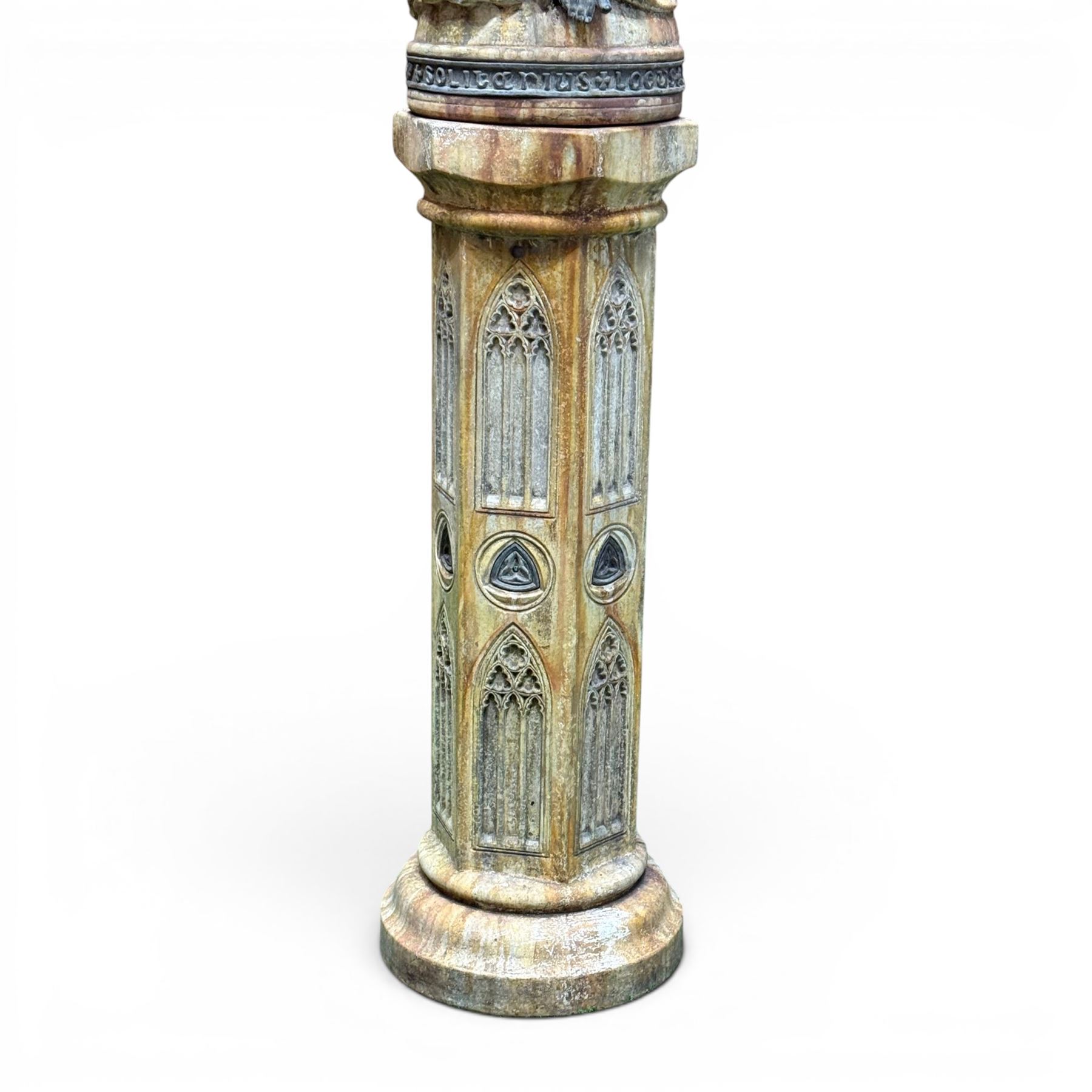 Farran stone garden statue depicting a hooded monk standing in flowing robes in circular form, set upon Gothic pedestal with arched panels, featuring lead hands and script band