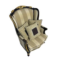 Thomas Messel - Georgian style ebonised and gilt wingback armchair, upholstered in striped fabric, on cabriole front feet