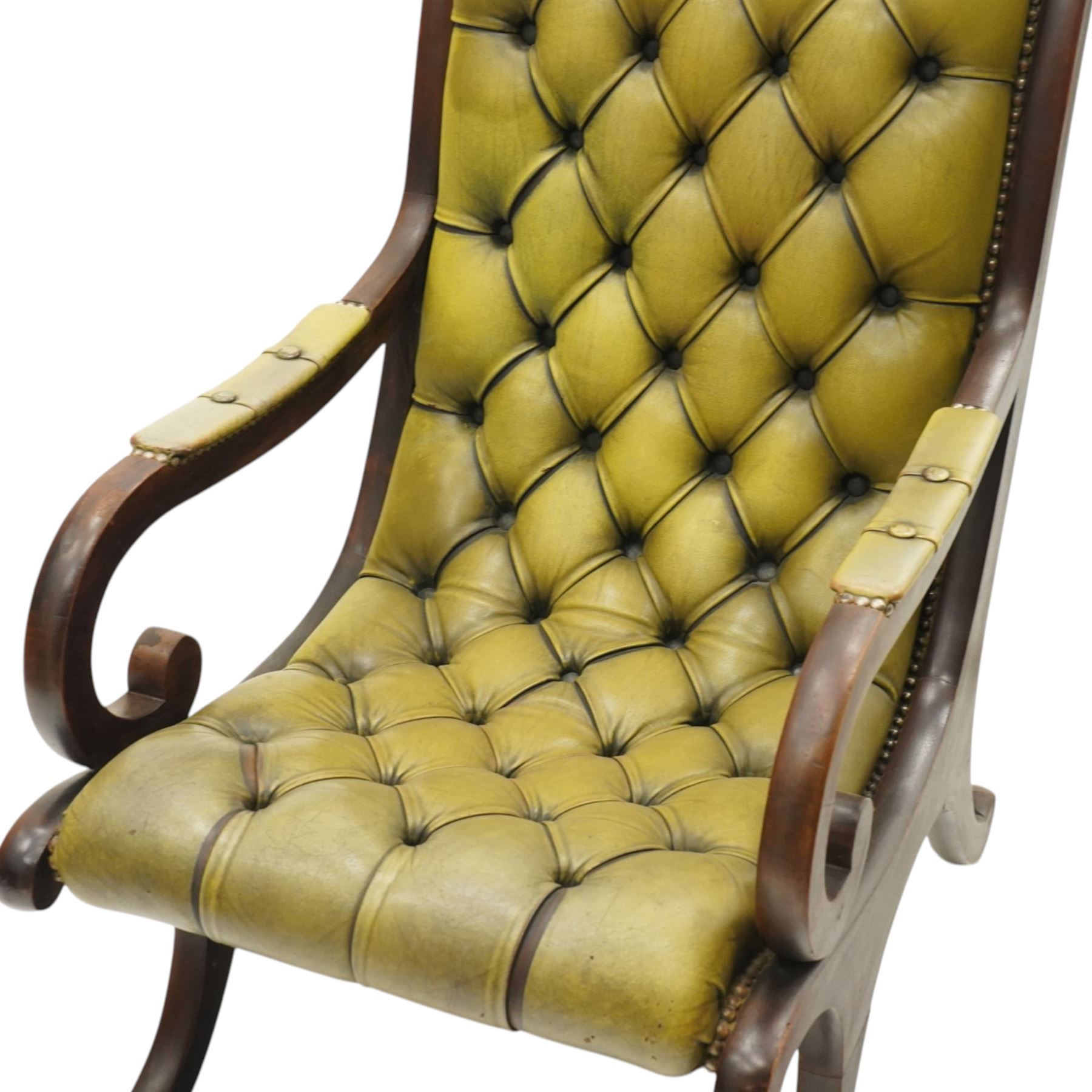 Regency design slipper chair upholstered in buttoned green leather, down swept arms with padded sections, swept back and shaped frames