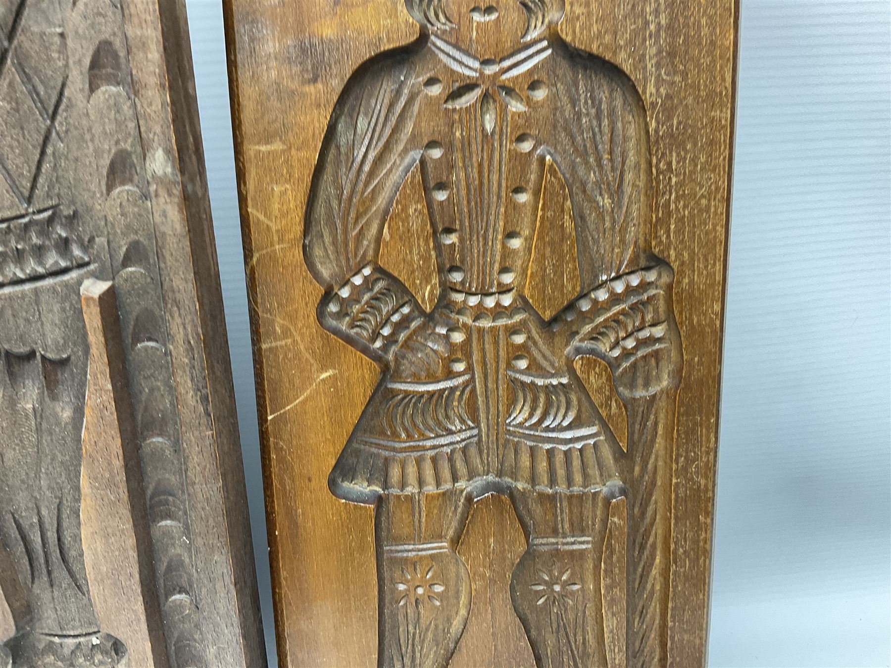 Six 20th century hardwood Dutch folk art Speculaasplank or biscuit moulds, typically carved with figures in traditional dress, largest H101cm