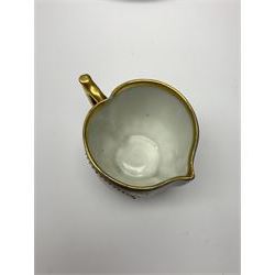 Vienna cabinet cup and saucer, the pedestal cup with funnel bowl decorated with a frieze of classical figures against a textured gilt background, and dark blue ground heightened with gilt, the saucer with raised centre and conforming dark blue gilt detailed ground, cup H10.5cm, saucer D15cm, together with a small Vienna jug of heart shaped form decorated with two circular panels of cupids, H5cm, each with blue 'beehive' mark beneath 