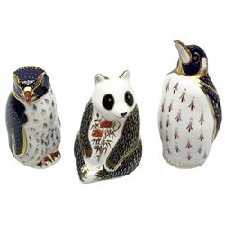Three Royal Crown Derby paperweights, comprising rockhopper penguin, designed by John Ablitt, with 21st anniversary hexagonal gold stopper, king penguin with silver stopper and a panda with silver stopper