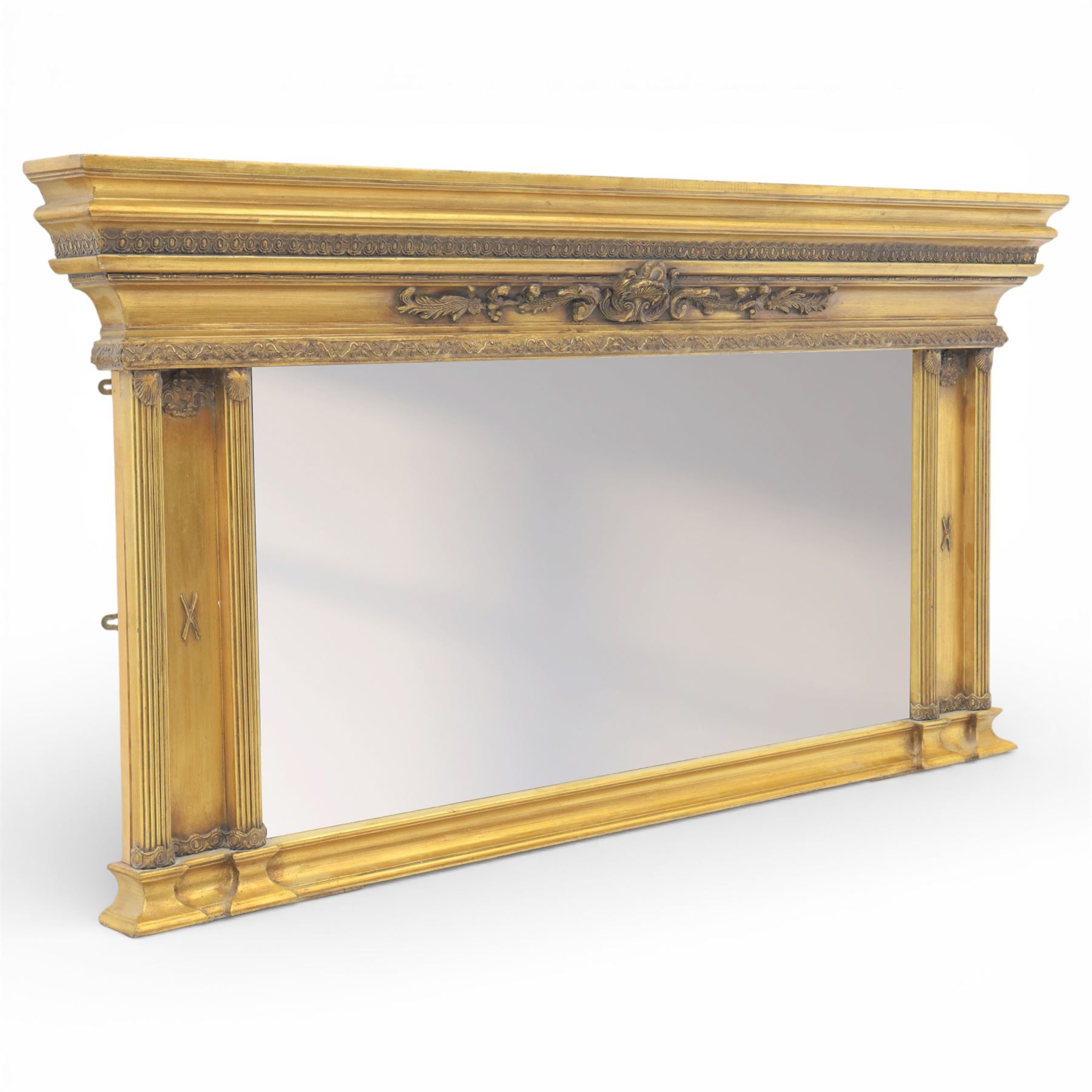 Early 20th century gilt over mantel mirror, the rectangular plate within stepped and moulded frame with central applied foliate ornament and fluted side uprights