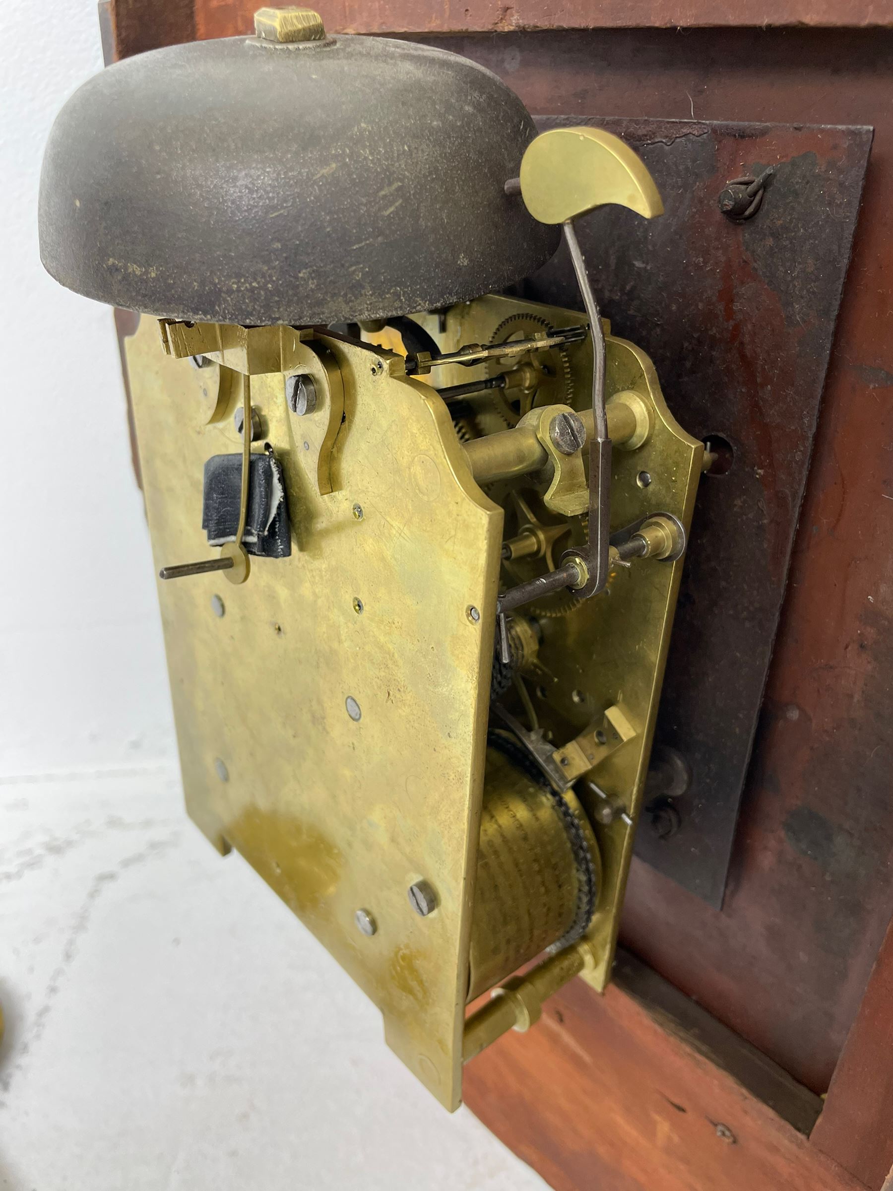 Joseph Critchley of Liverpool -  early 19th century twin fusee 8-day rosewood and mother of pearl inlaid drop-dial wall clock c1820, inlaid circular wooden dial surround with carved ears representing grapes and vine leaves, glazed box with a scroll carved surround, curved base and pendulum adjustment door, 14” painted dial with Roman numerals, minute track, and pierced steel hands within a cast brass bezel and flat glass, dial pinned to a four pillar chain driven fusee movement striking the hours on a bell. With pendulum and key.