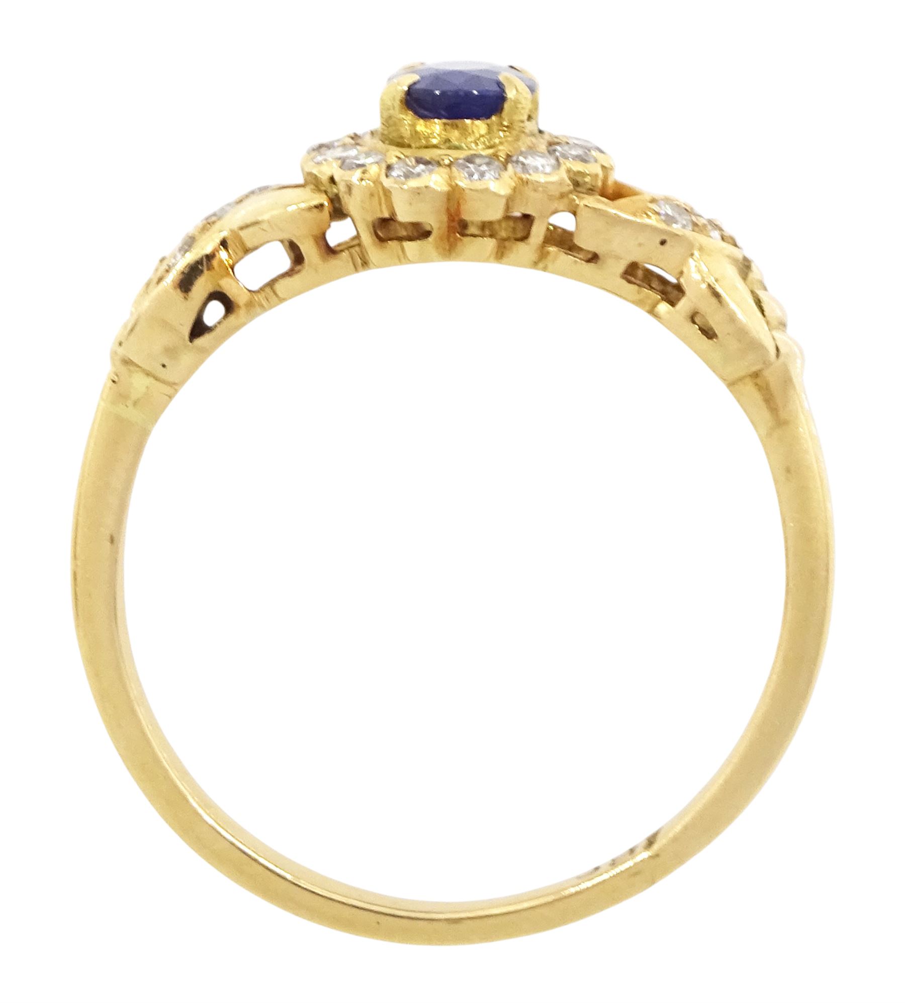 18ct gold sapphire and diamond cluster ring, single oval cut sapphire of approx 0.50 carat, surrounded by fourteen round brilliant cut diamonds, with pierced crossover diamond set shoulders, stamped, total diamond weight approx 0.20 carat